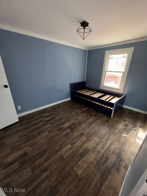 unfurnished bedroom with dark hardwood / wood-style floors