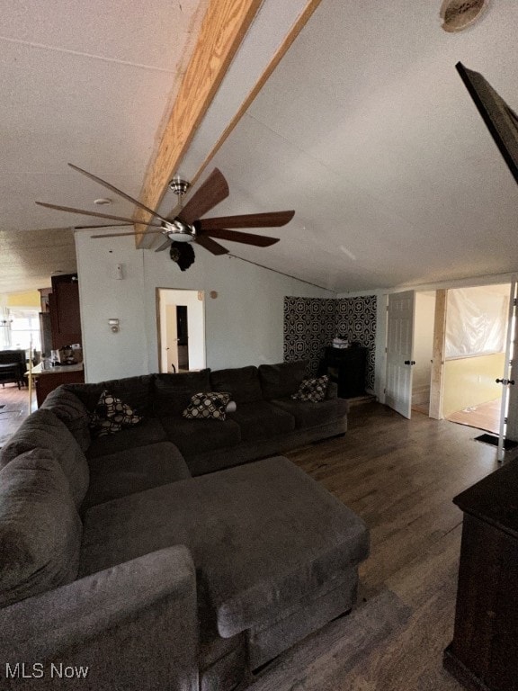 living room featuring hardwood / wood-style floors, lofted ceiling with beams, and ceiling fan