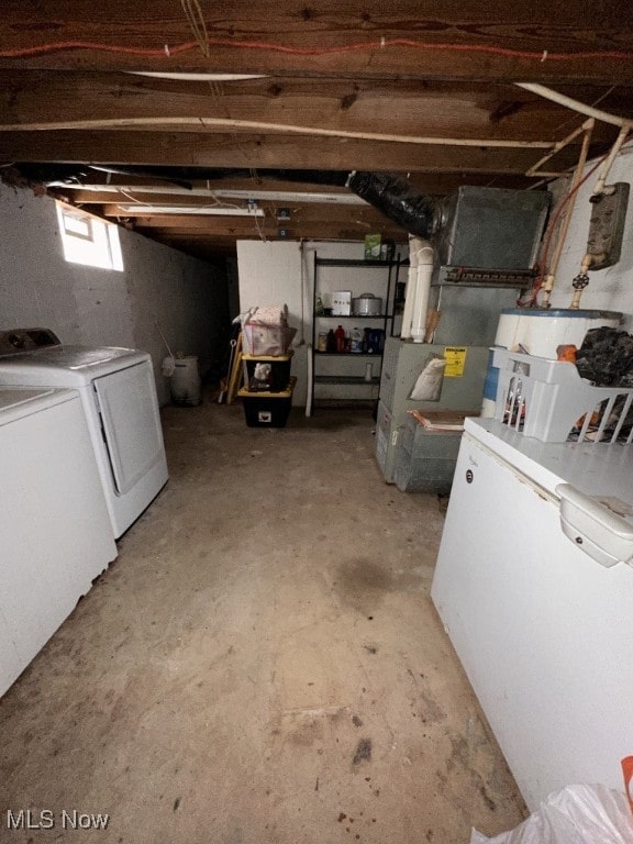 basement featuring independent washer and dryer and refrigerator