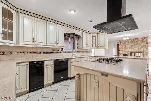 kitchen featuring stainless steel gas cooktop, glass insert cabinets, cream cabinets, range hood, and black dishwasher
