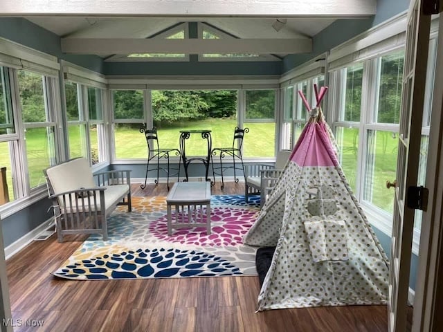 sunroom with lofted ceiling with beams