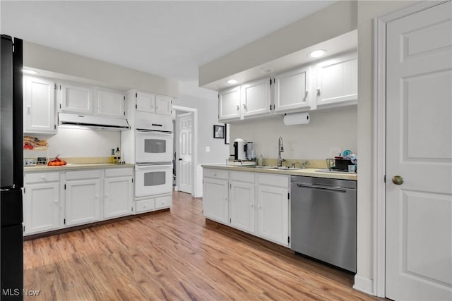 kitchen with white cabinetry, light hardwood / wood-style floors, sink, and black appliances