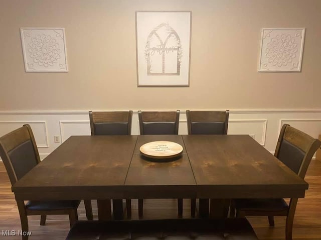 dining space with hardwood / wood-style flooring