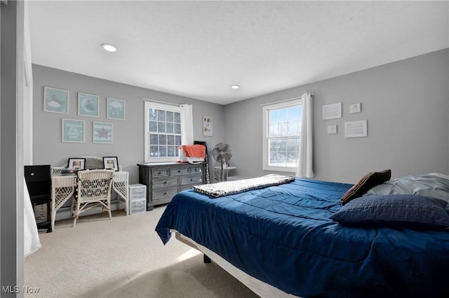 bedroom featuring light carpet