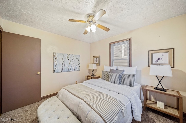 carpeted bedroom with ceiling fan and a textured ceiling