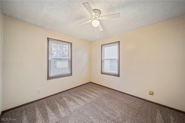 carpeted spare room with ceiling fan and a textured ceiling