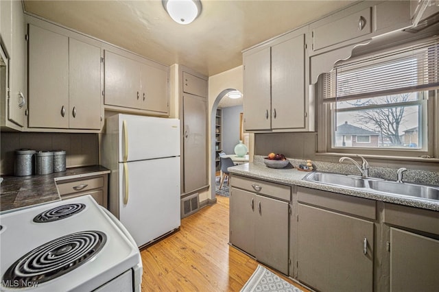 kitchen featuring white appliances, gray cabinets, sink, and light hardwood / wood-style flooring