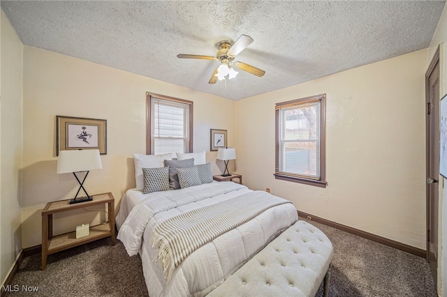 bedroom featuring multiple windows, ceiling fan, carpet floors, and a textured ceiling