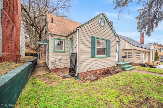 view of property exterior with a yard