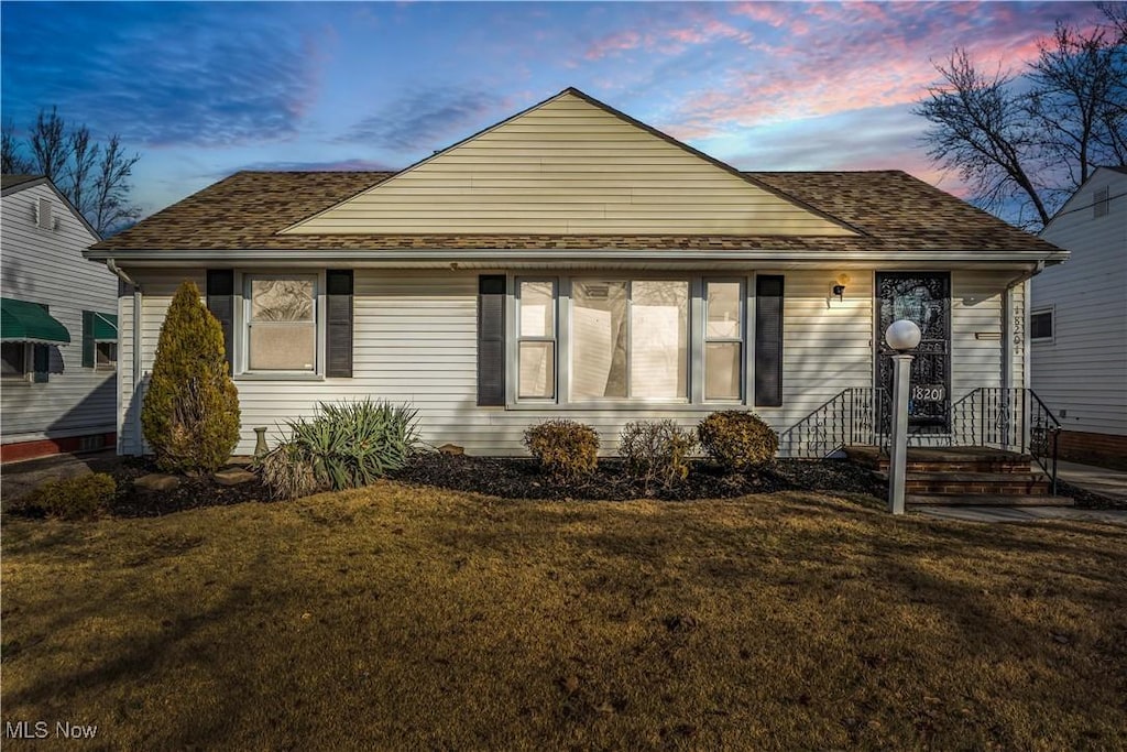 bungalow-style house featuring a yard