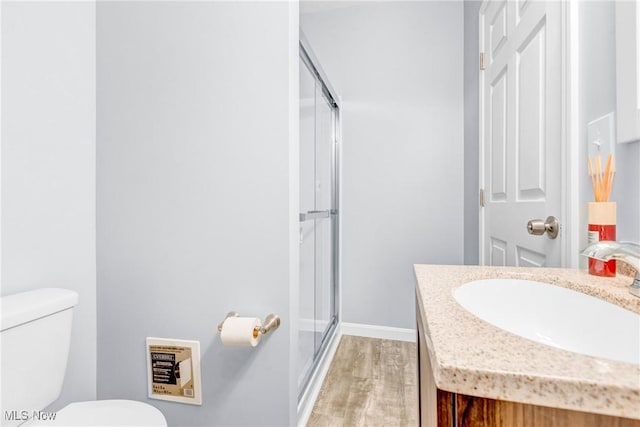 24512 Emery Rd, Warrensville Heights, OH 44128 - bathroom featuring walk in shower, vanity, toilet, and hardwood / wood-style flooring