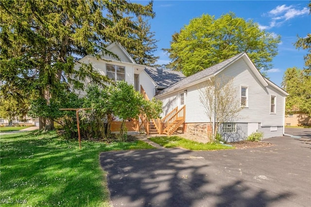 view of side of property with a lawn