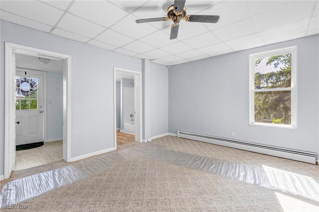 24512 Emery Rd, Warrensville Heights, OH 44128 - spare room with a drop ceiling, plenty of natural light, light colored carpet, and baseboard heating