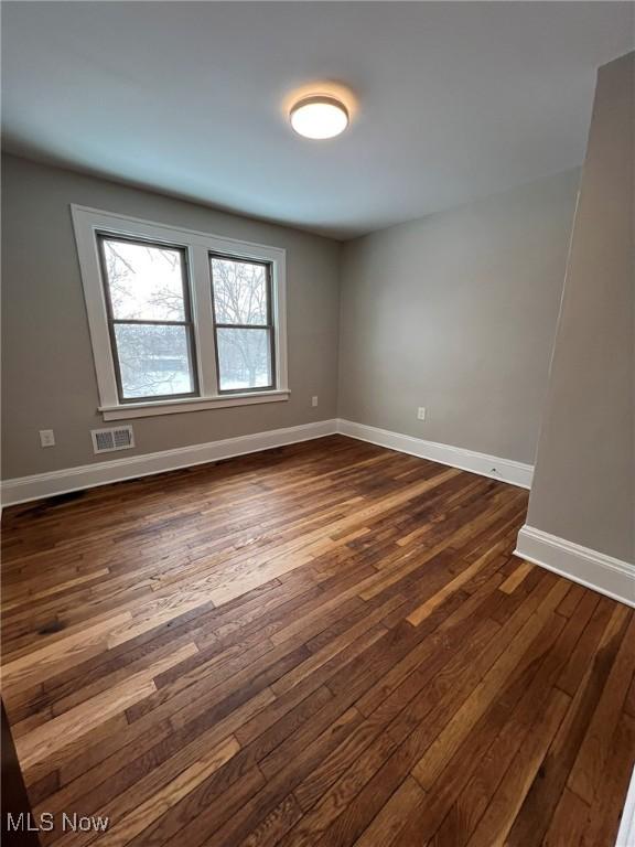 empty room with dark hardwood / wood-style floors