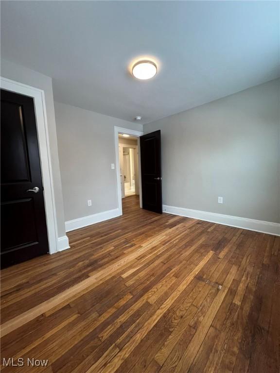 unfurnished bedroom featuring dark hardwood / wood-style floors