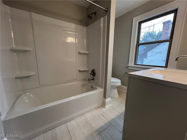 full bathroom featuring bathtub / shower combination, vanity, and toilet