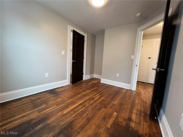 unfurnished room featuring dark hardwood / wood-style flooring