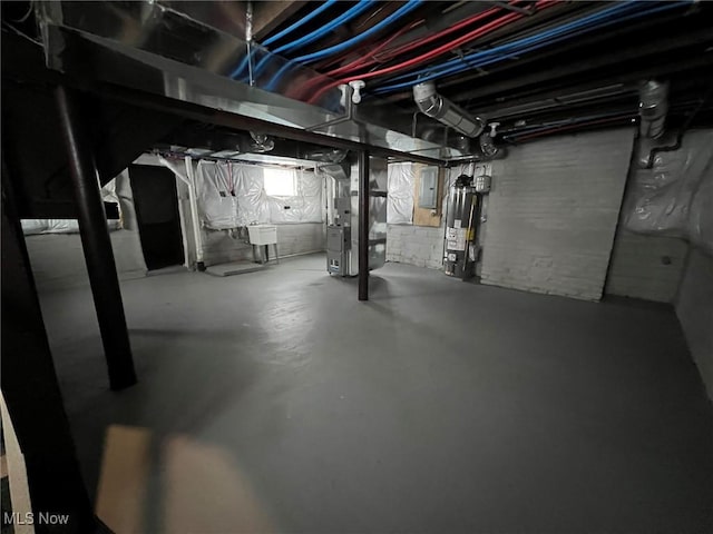 basement featuring gas water heater and heating unit