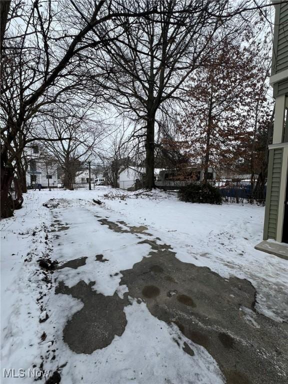 view of yard layered in snow