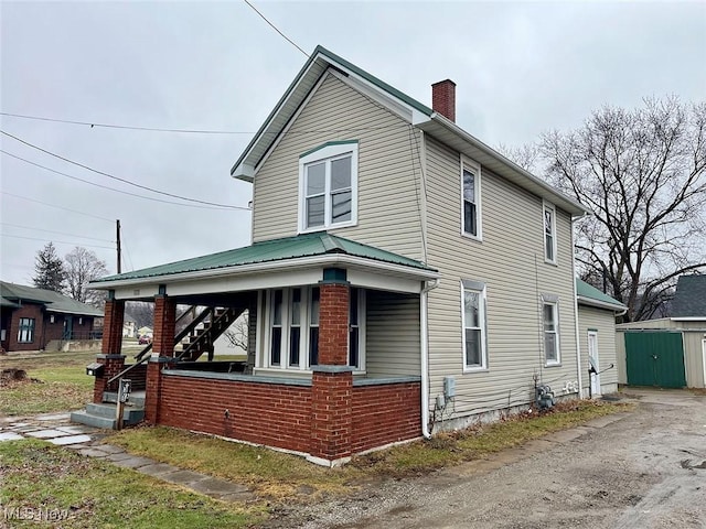 view of side of home featuring a porch