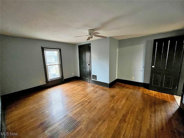 spare room with hardwood / wood-style flooring and ceiling fan