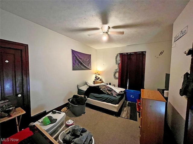 carpeted bedroom featuring a textured ceiling and ceiling fan