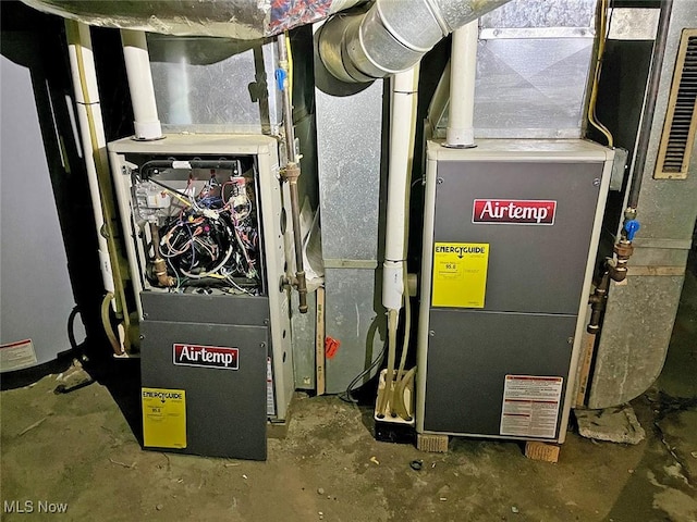 utility room featuring heating unit