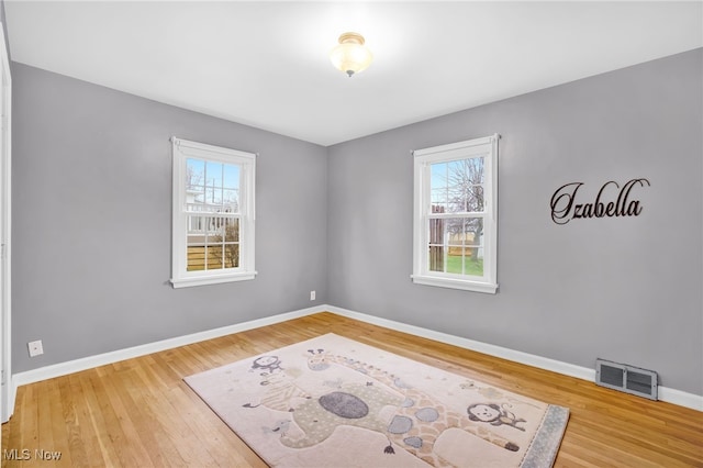 unfurnished room featuring hardwood / wood-style flooring