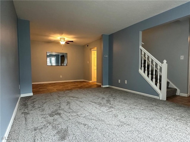 unfurnished living room featuring carpet and ceiling fan