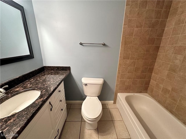 full bathroom with tile patterned flooring, vanity, tiled shower / bath, and toilet