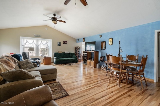 living room featuring vaulted ceiling, ceiling fan, and light hardwood / wood-style floors