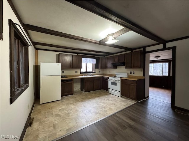 kitchen with dark brown cabinetry, beam ceiling, white appliances, and light hardwood / wood-style floors