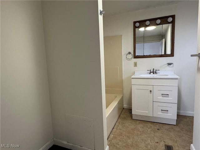 bathroom with vanity and a bath