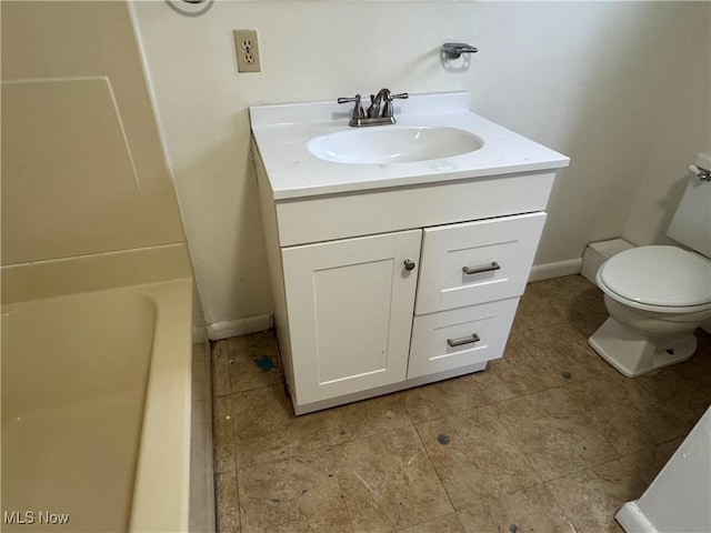 bathroom with vanity, tile patterned floors, a bathing tub, and toilet