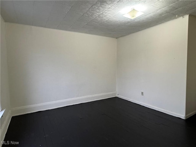 unfurnished room featuring dark hardwood / wood-style floors