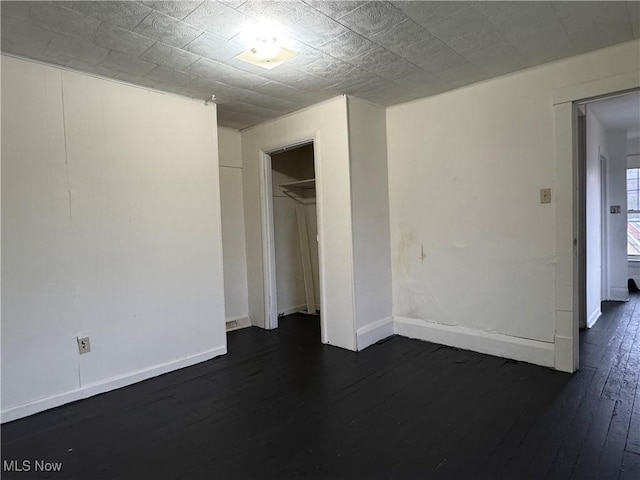 spare room featuring dark wood-type flooring