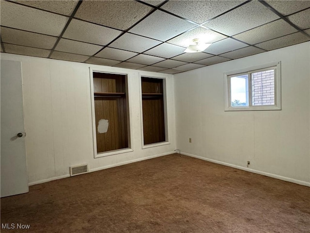 interior space with carpet and a paneled ceiling