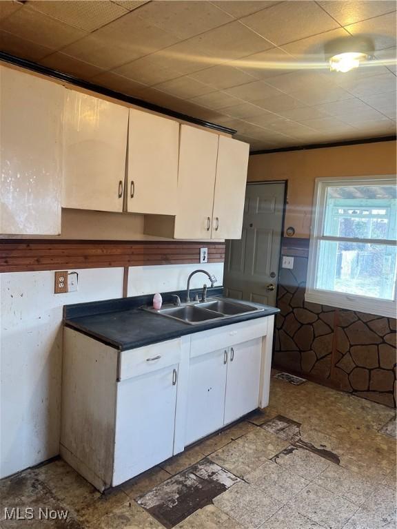 kitchen featuring white cabinetry and sink