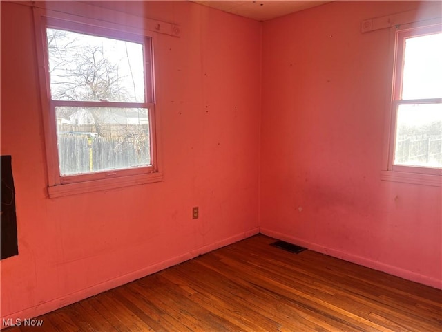 unfurnished room with plenty of natural light and wood-type flooring