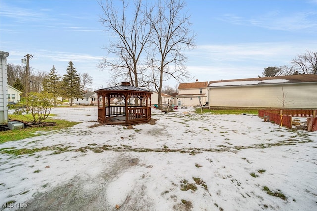 yard covered in snow with a gazebo