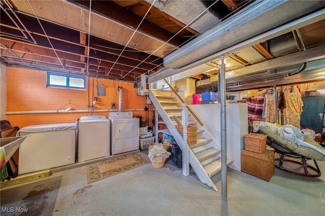 basement featuring refrigerator and washer and clothes dryer