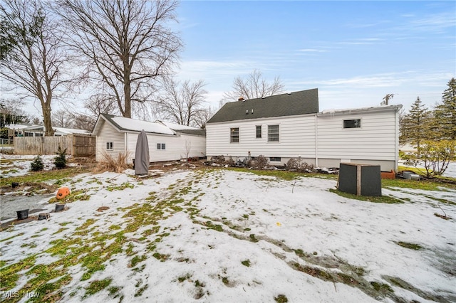 view of snow covered back of property