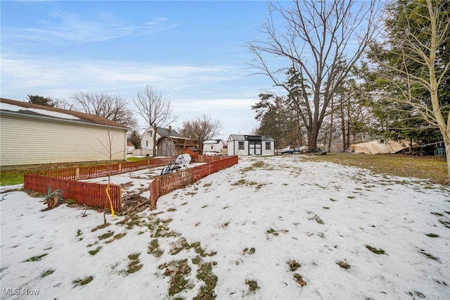 snowy yard with a storage unit