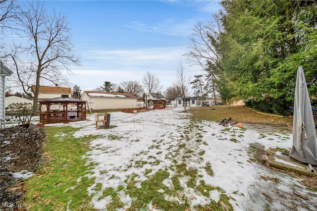 yard covered in snow featuring a gazebo