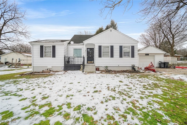 view of front of home featuring a garage and an outdoor structure