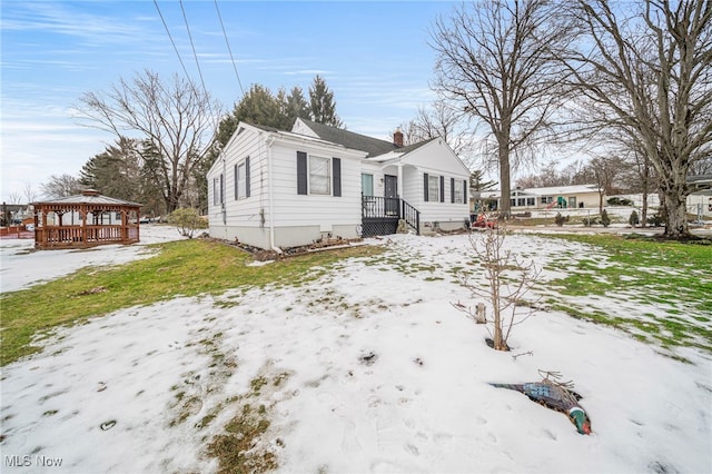 view of front of property with a gazebo and a yard