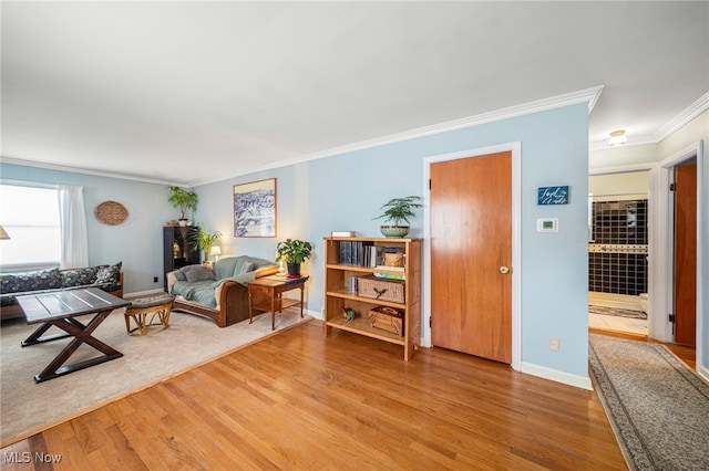 living room featuring wood-type flooring and ornamental molding