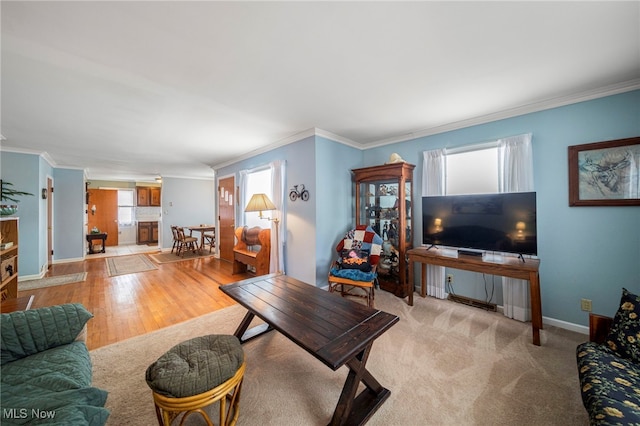 carpeted living room featuring ornamental molding