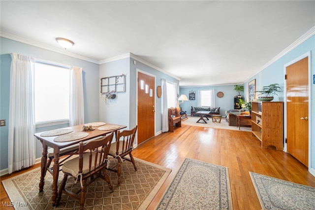 dining room with wood-type flooring and ornamental molding