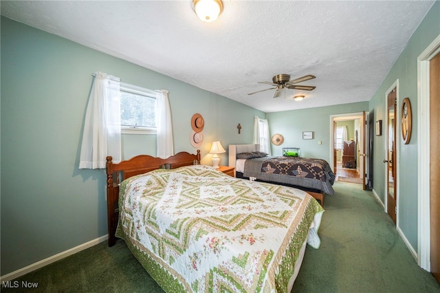 carpeted bedroom featuring ceiling fan and a textured ceiling